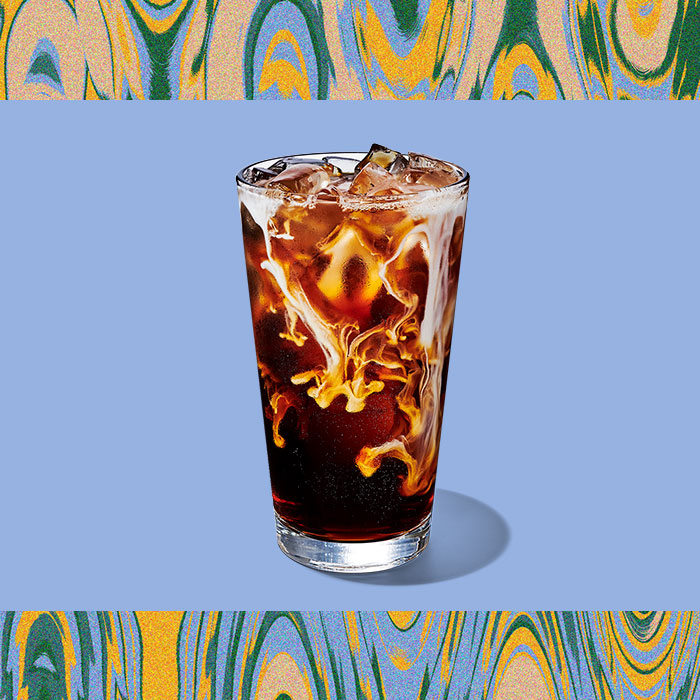 Iced Vanilla Sweet Cream Cold Brew in a clear glass on a light blue background