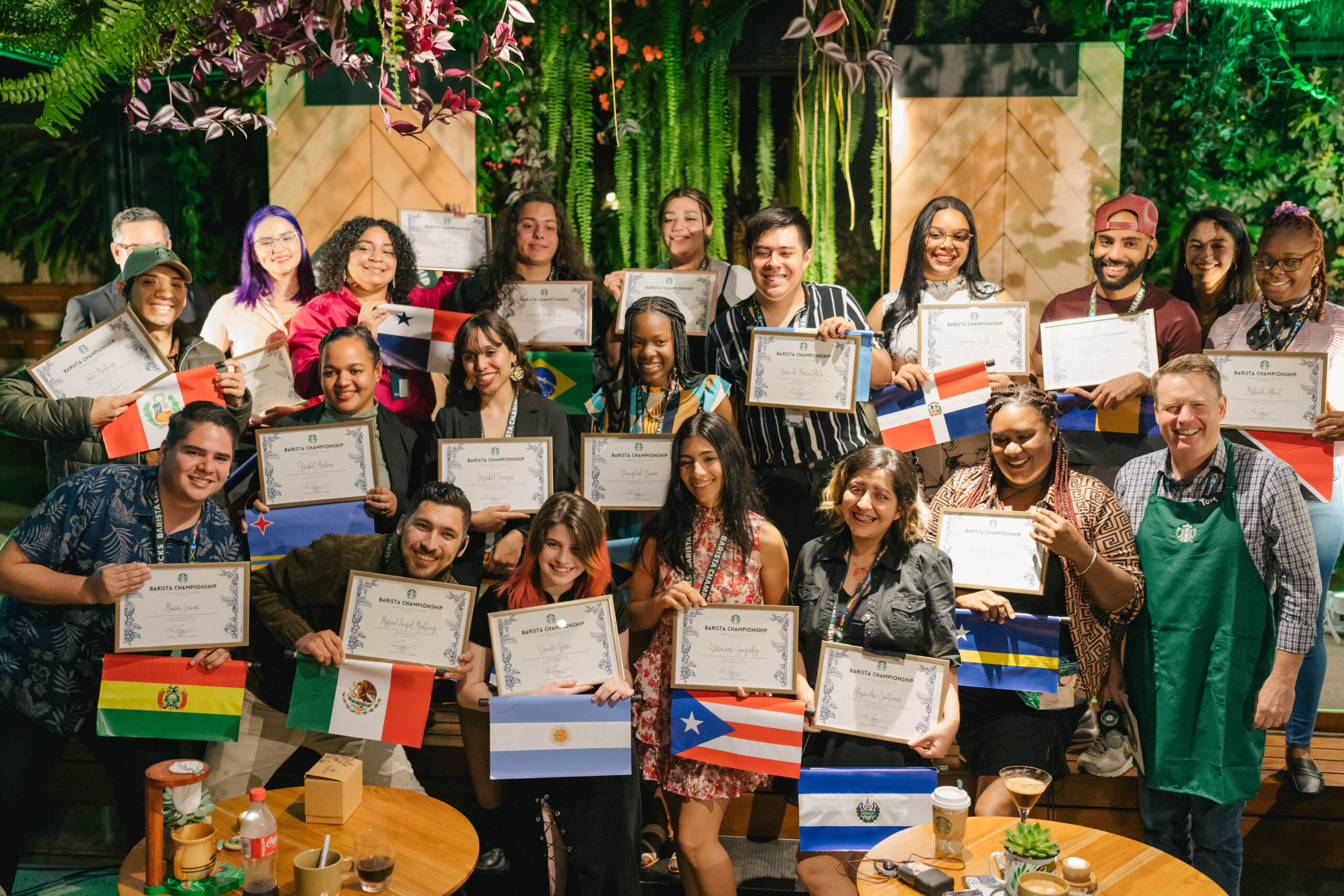 International Barista champions from around the world holding their home country flag and certificate