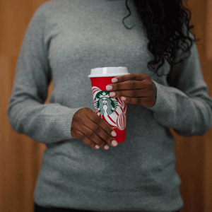A gif of a person holding red reusable cup