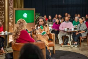 Oprah having a conversation with an author and the audience