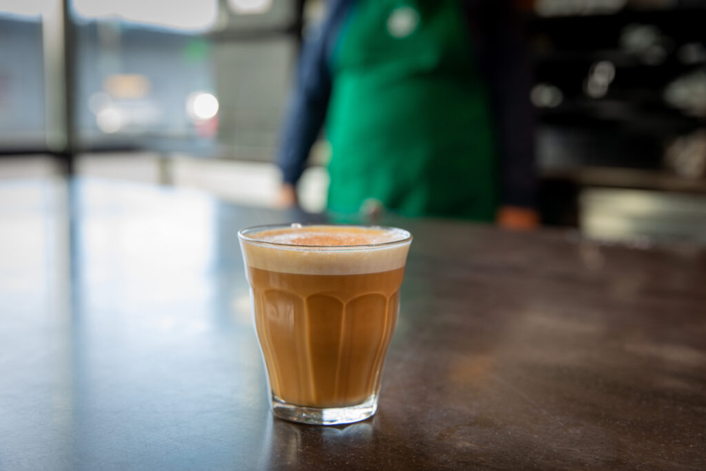 A small glass of Starbucks Cortado on the counter