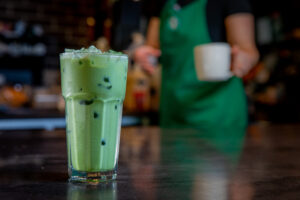 A glass of Starbucks Iced Matcha on the counter
