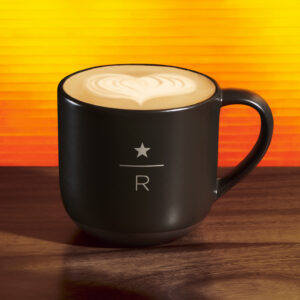Starbucks reserve dirty chai in black mug on an orange background