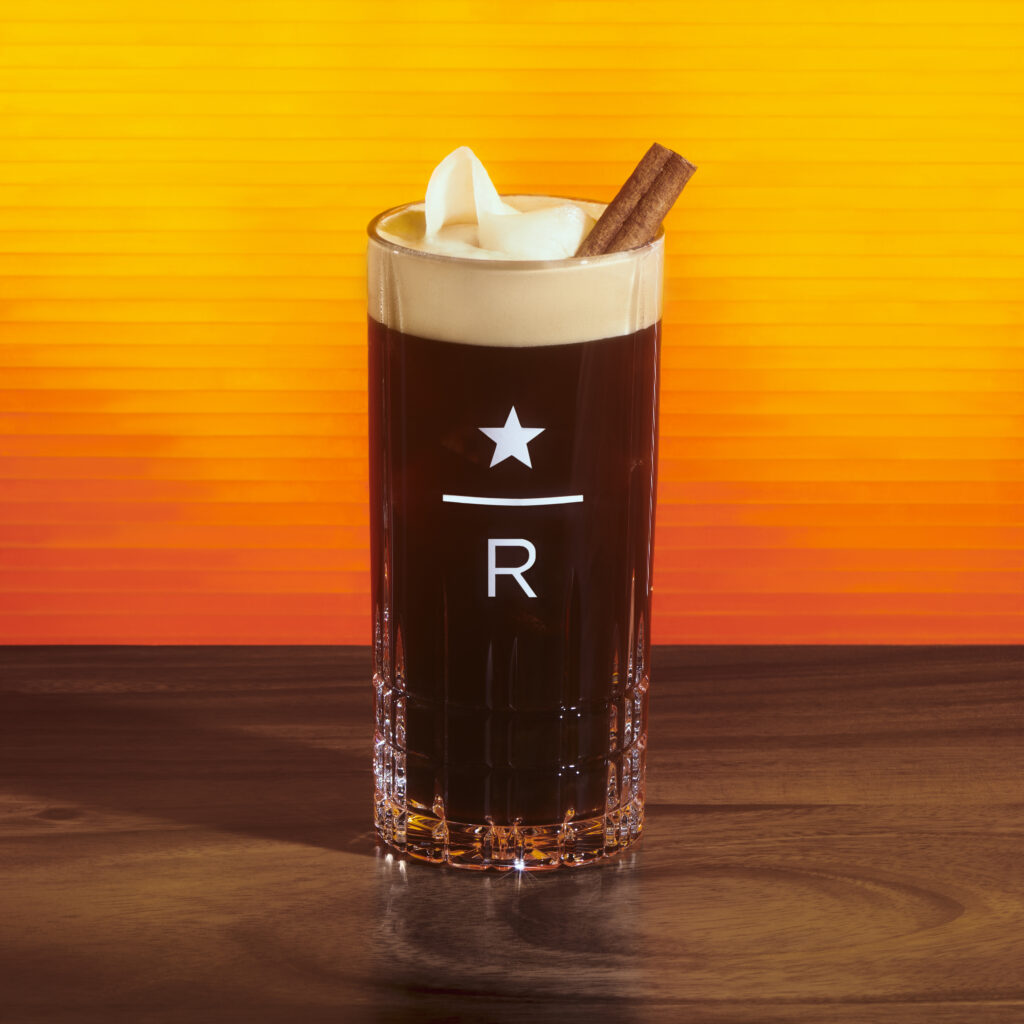 Starbucks hot honey Ginger Spritz in a glass on an orange background