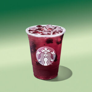 A cup of Starbucks Blackberry Sage Refresher on a light green background