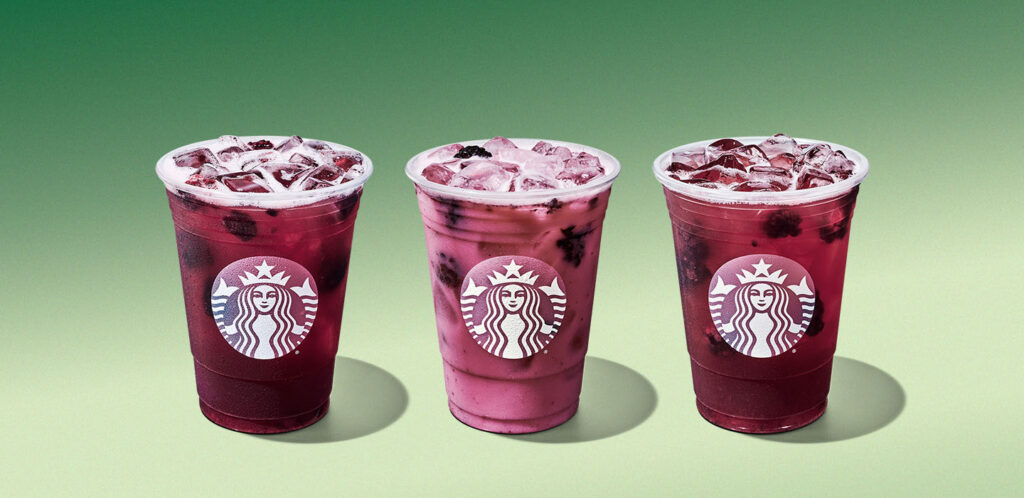 A lineup of Starbucks Blackberry Sage Refreshers on a a light green background