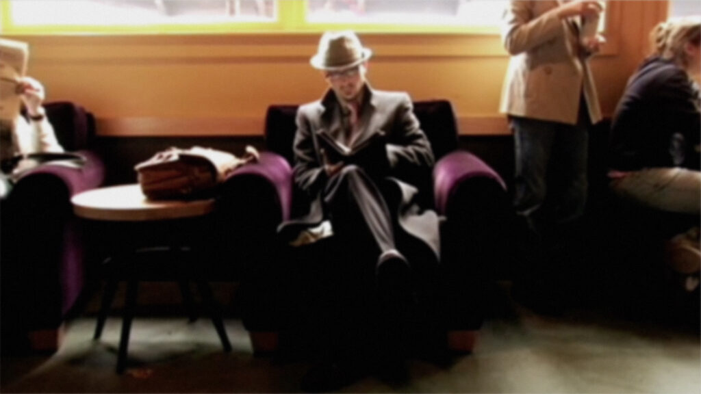 **Alt text:** Man reading newspaper.