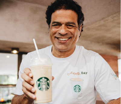 Rai Holds up Frappuccino during Caramel Day